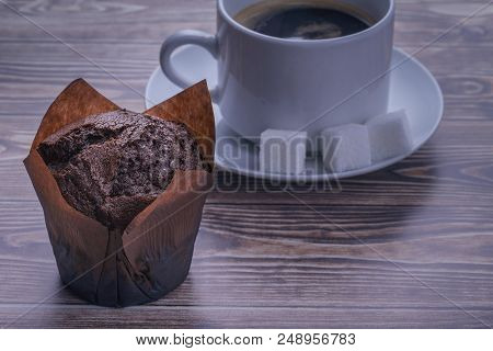 Fresh Chocolate  Muffin And A Cup Of Coffee Close-up
