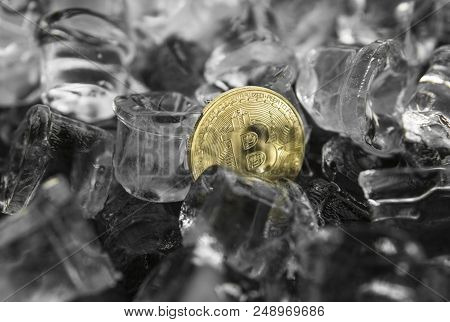 Gold Bitcoin On Ice Background. The Concept Of The Exchange In Winter. Freeze. Blockchain Mining. Di