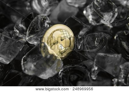 Gold Ripple Coin On Ice Background. The Concept Of The Exchange In Winter. Freeze. Blockchain Mining