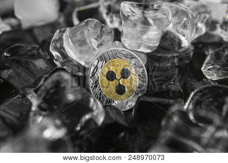 Gold Ripple Coin On Ice Background. The Concept Of The Exchange In Winter. Freeze. Blockchain Mining