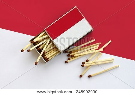 Indonesia Flag  Is Shown On An Open Matchbox, From Which Several Matches Fall And Lies On A Large Fl