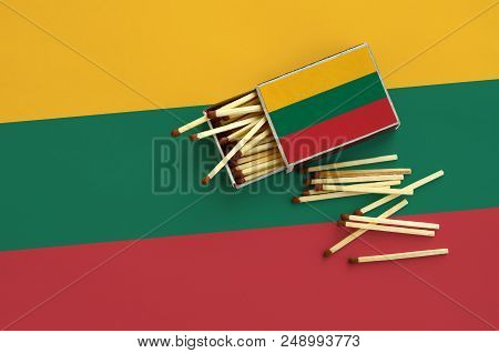 Lithuania Flag  Is Shown On An Open Matchbox, From Which Several Matches Fall And Lies On A Large Fl