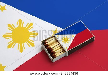 Philippines Flag  Is Shown In An Open Matchbox, Which Is Filled With Matches And Lies On A Large Fla