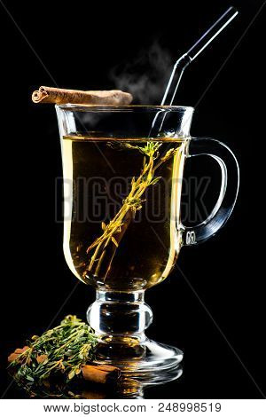 Hot Amaro Cocktail With Apple Juice And Cinnamon With Steam Isolated On Black Background