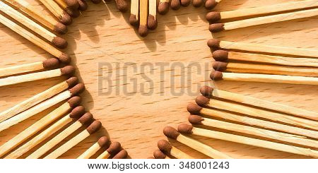 Wooden Safety Matches On A Wooden Background Arranged In The Shape Of A Heart. Matchsticks In The Sh
