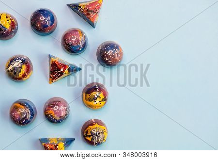 Colorful Trendy Blue, Red, Yellow Chocolate Pralines On Pastel Blue Background. Modern Chocolate Des