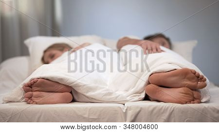 Young Man And Woman Sleeping Back To Back, Conflict In Bed, Couple Relationship
