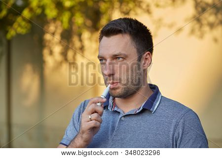 Electronic Cigarettes, Cigarette Technology. Tobacco Iqos System. Close-up Of A Man Smoking An Elect