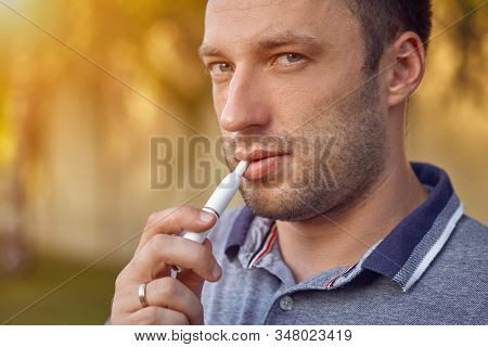 Electronic Cigarettes, Cigarette Technology. Tobacco Iqos System. Close-up Of A Man Smoking An Elect
