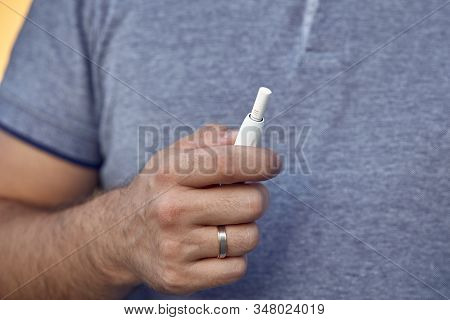 Electronic Cigarettes, Cigarette Technology. Tobacco Iqos System. Close-up Of A Man Smoking An Elect