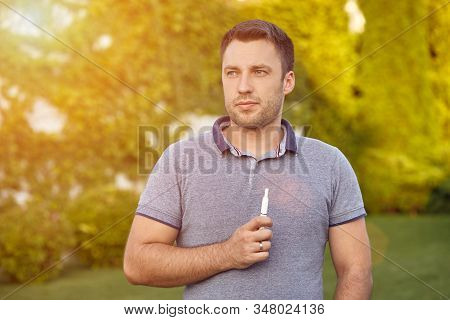 Electronic Cigarettes, Cigarette Technology. Tobacco Iqos System. Close-up Of A Man Smoking An Elect