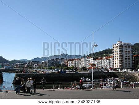 People Walking At The Port In Castro Urdiales, Spain