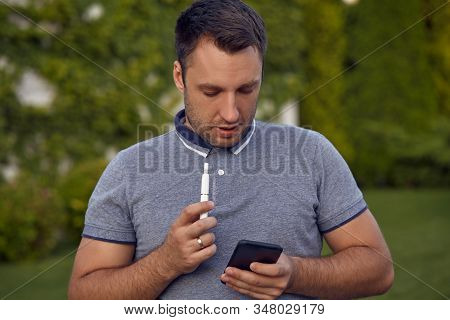 Electronic Cigarettes, Cigarette Technology. Tobacco Iqos System. Close-up Of A Man Smoking An Elect