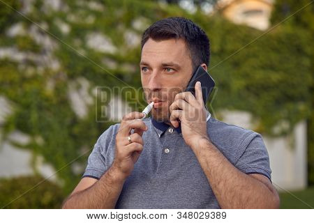 Electronic Cigarettes, Cigarette Technology. Tobacco Iqos System. Close-up Of A Man Smoking An Elect