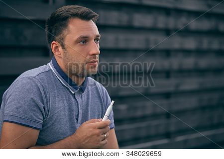 Electronic Cigarettes, Cigarette Technology. Tobacco Iqos System. Close-up Of A Man Smoking An Elect