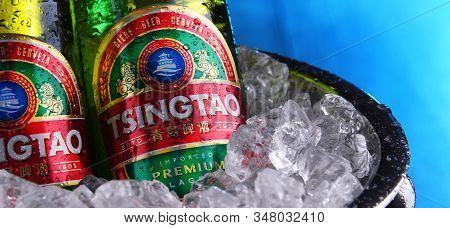 Two Bottles Of Tsingtao Beer In Bucket With Crushed Ice