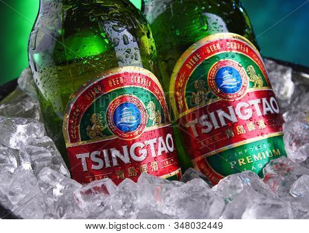 Two Bottles Of Tsingtao Beer In Bucket With Crushed Ice