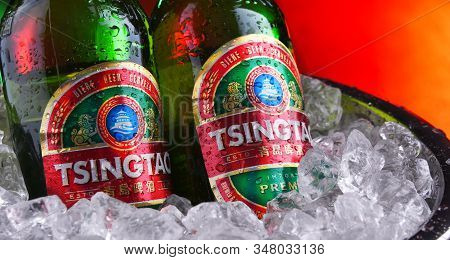 Two Bottles Of Tsingtao Beer In Bucket With Crushed Ice