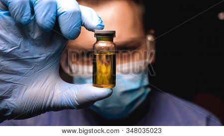 Laboratory worker scientist laboratory assistant tests chemicals for reactions in flask, interfering