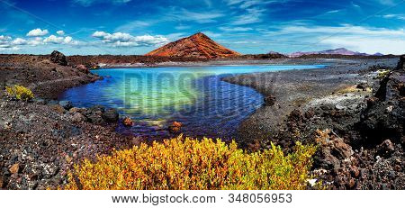Impressive And Scenic Volcanic Nature Unique In Timanfaya National Park.red Mountain And Green Puddl
