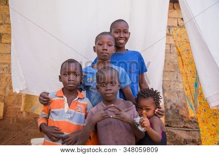 Bissau, Guinea-Bissau - January 5, 2020: group of African Kids looking at the camera in rural Guinea-Bissau