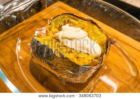 Homemade Baked Potatoe In Foil With Sour Cream, Selective Focus.