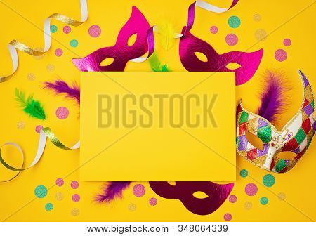 Festive, Colorful Mardi Gras Or Carnivale Mask And Accessories Over Yellow Background. Party Invitat