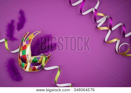 Festive, Colorful Mardi Gras Or Carnivale Mask And Accessories Over Purple Background. Party Invitat