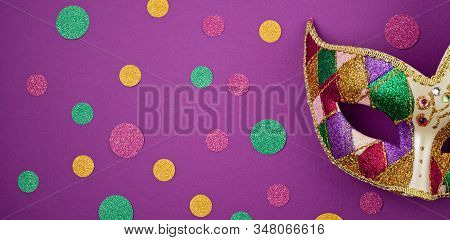 Banner With Festive, Colorful Mardi Gras Or Carnivale Mask And Accessories Over Purple Background. P