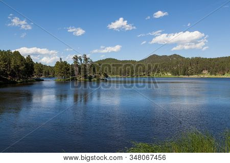 Stockade Lake In Custer State Park On A Clear Spring Day With Calm Water And People Enjoying The Wea