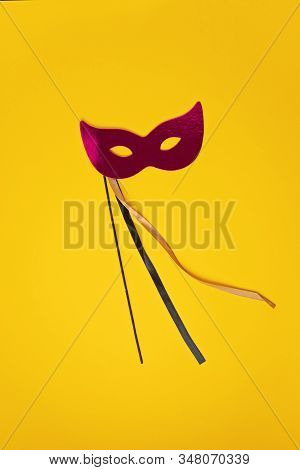 Festive, Colorful Mardi Gras Or Carnivale Mask And Accessories Over Yellow Background. Party Invitat