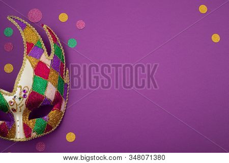 Festive, Colorful Mardi Gras Or Carnivale Mask And Accessories Over Purple Background. Party Invitat