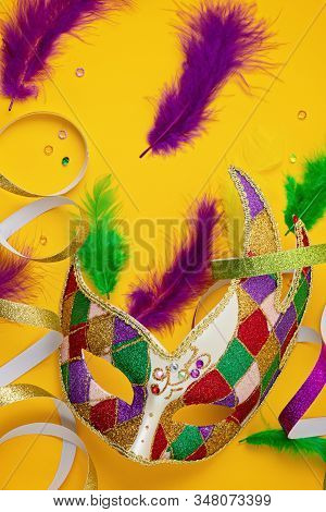 Festive, Colorful Mardi Gras Or Carnivale Mask And Accessories Over Yellow Background. Party Invitat