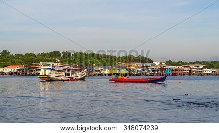 Labuan,malaysia-jan 31,2020:view Of Traditional Fishing Boats With Background Of Water Village Of Pa