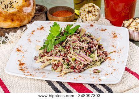 Lobio Salad On A White Plate Shot In The Decor.