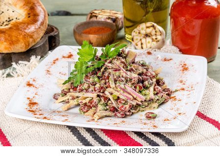 Lobio Salad On A White Plate Shot In The Decor.