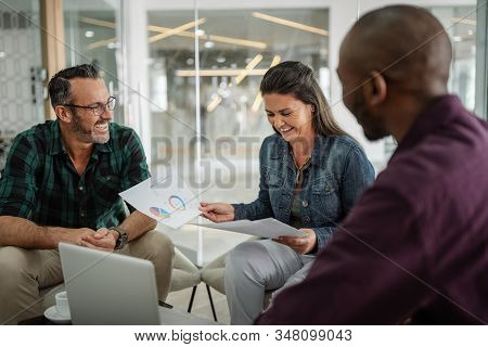 Happy Smiling Successful Business Colleagues Having A Candid Seated Casual Meeting