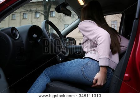 Woman Suffering From Hemorrhoid Pain In Car