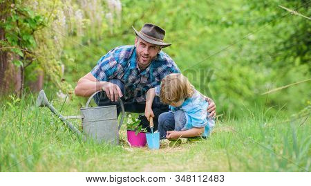 Growing Plants. Take Care Of Plants. Boy And Father In Nature With Watering Can. Gardening Tools. Pl