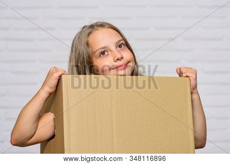 Make Moving Easier. Girl Small Child Carry Cardboard Box. Move Out Concept. Delivering Your Purchase