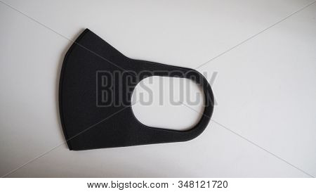 Black Mask Help To Protect Coronavirus Virus And Dust And Other Particle, Put On White Background.