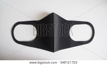 Black Mask Help To Protect Coronavirus Virus And Dust And Other Particle, Put On White Background.