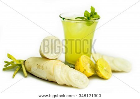 Close Up Shot Of Fresh Daikon Juice In A Glass Isolated On A White Background Along With Some Sliced