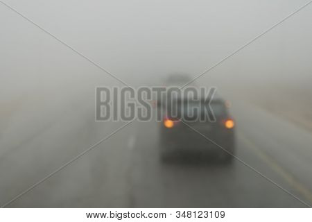 Poor Visibility On The Road. Fog Early In The Morning On The Highway. Slow-moving Cars In Heavy Smok
