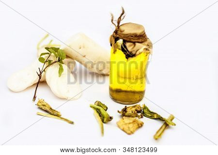 Freshly Sliced Daikon Radish Or White Radish Along With Its Seed Oil In A Glass Bottle Isolated On W