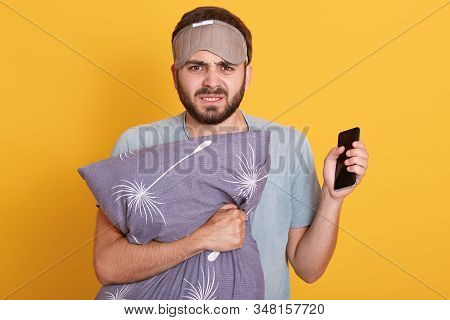 Close Up Portrait Of Angry Annoyed Young Man Standing Isolated Over Yellow Background In Studio, Hav