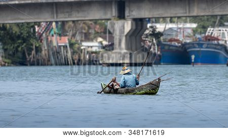 Indian Fishermen In Kerela With Traditional Canoe