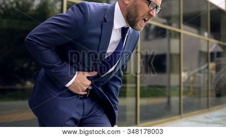 Worker In Suit Suffering From Stomach Ache, Abdominal Pain, Gastroenteritis