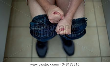 Suffering From Constipation Male Sitting On Toilet, Health Care, Strong Pain
