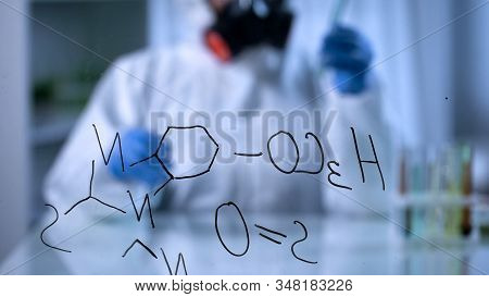 Toxicologist Compounding Biochemical Liquids In Test Tube, Formula On Foreground